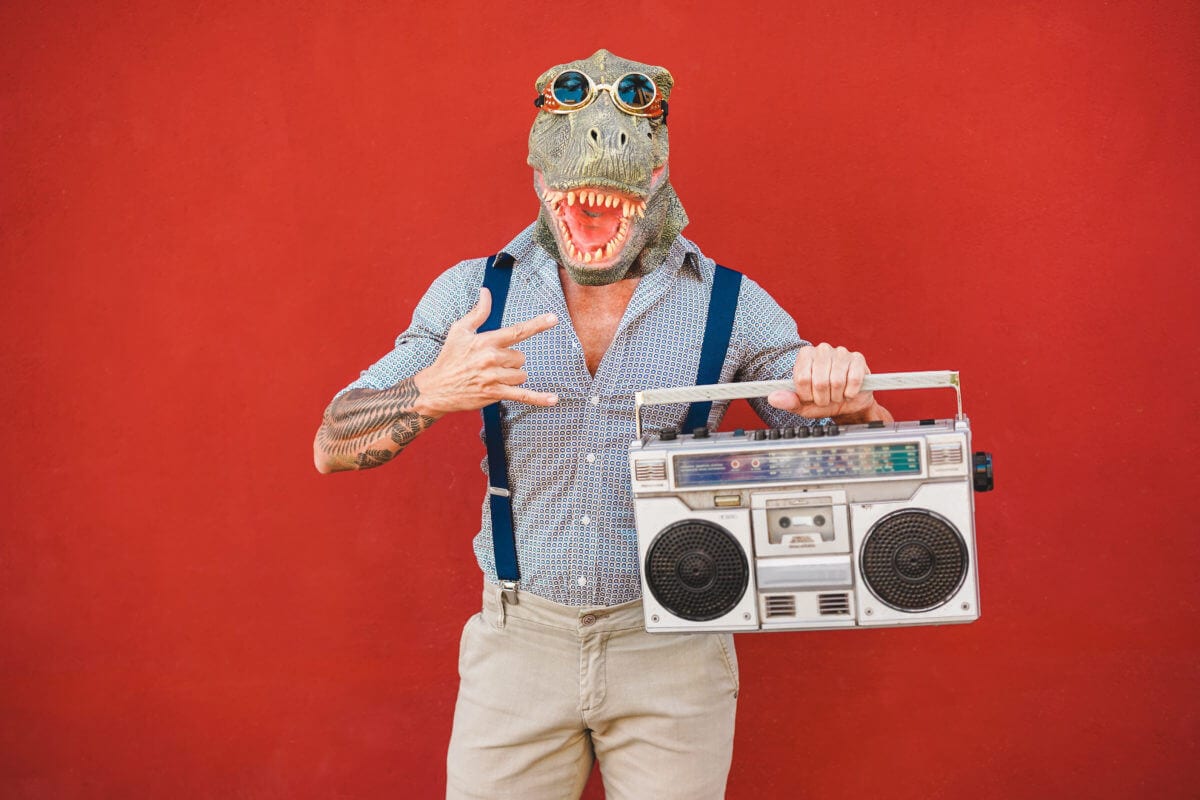 man dancing rock music wearing t-rex mask