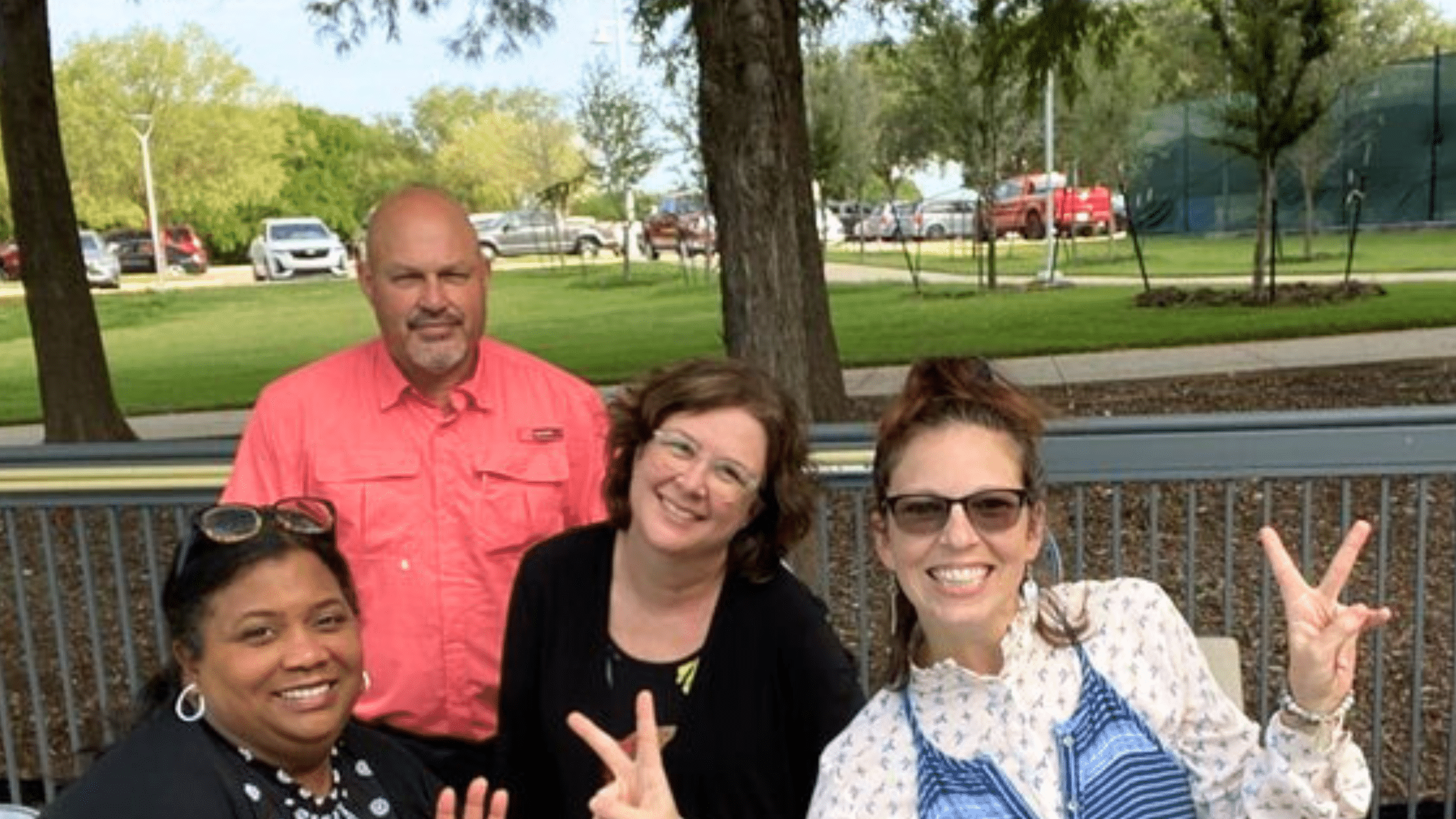 A team smiling and enjoying themselves during an Adventure Games Inc. team building event in Dallas Texas