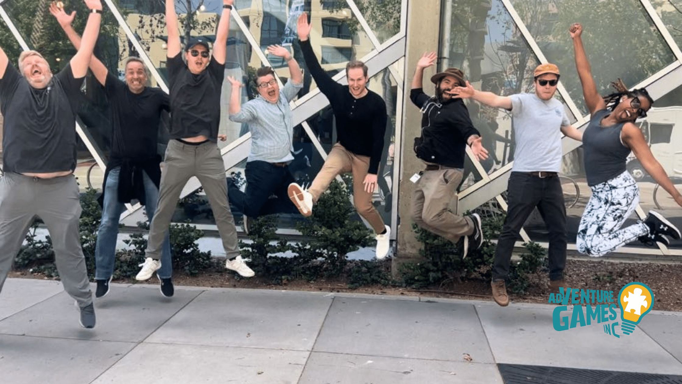 Employees celebrating success during a high-energy team building event run by Adventure Games Inc, a top-rated provider of team connection experiences