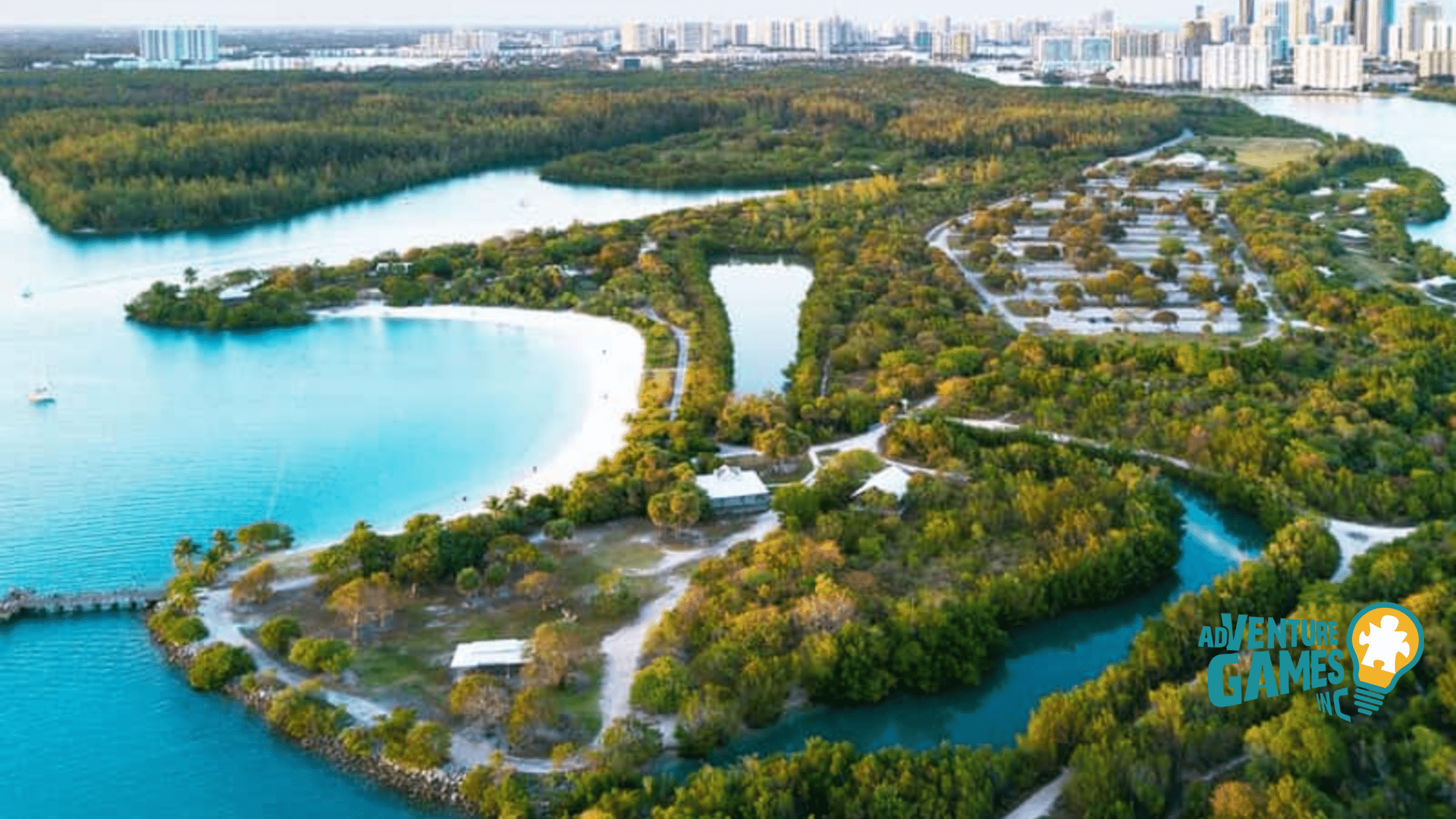 Aerial view of Oleta River State Park in Miami Florida, featuring winding mangrove-lined waterways, sandy launch areas and lush groves ideal for kayak team building activities.