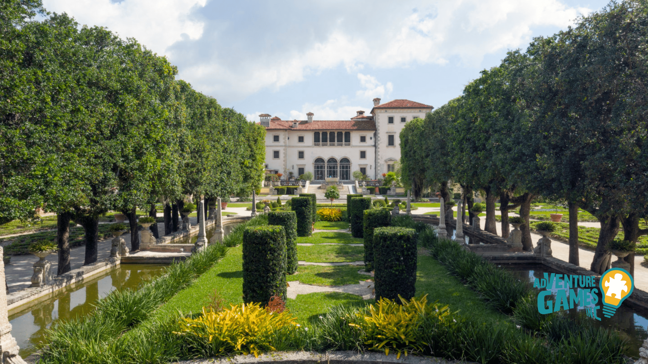 Formal Italian‑style gardens at Vizcaya Museum & Gardens in Miami Florida, featuring symmetrical hedges, reflecting pools and the historic villa facade in the background.