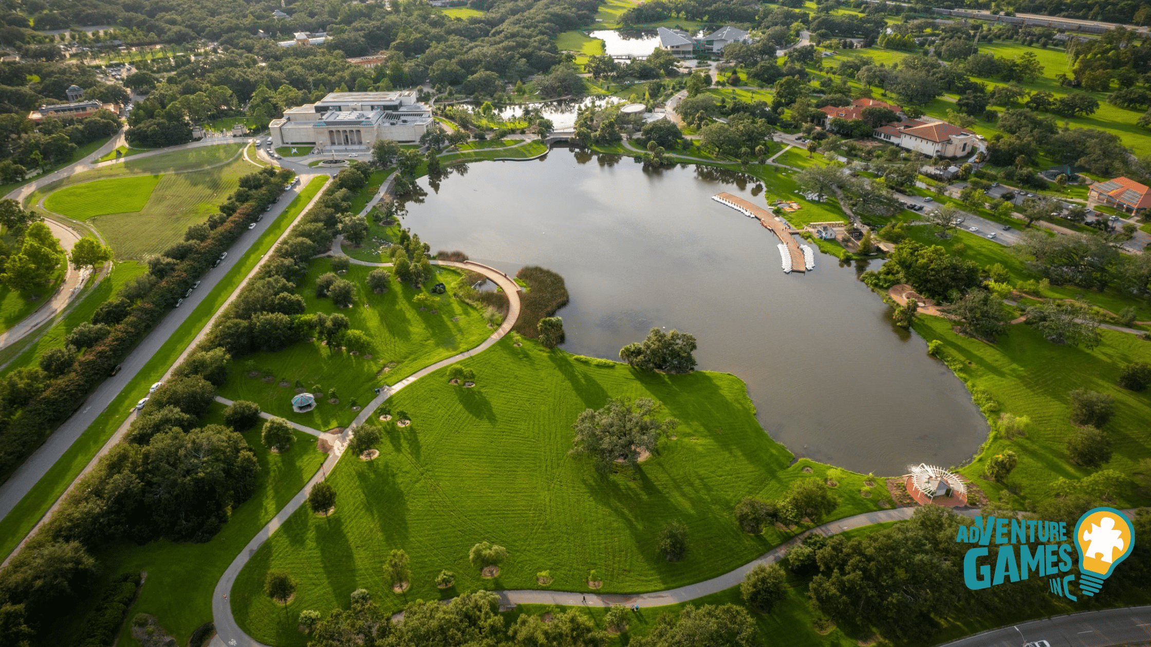 Aerial view of City Park’s Big Lake and New Orleans Museum of Art, with open lawns, trails and a boat dock for flexible outdoor team building.