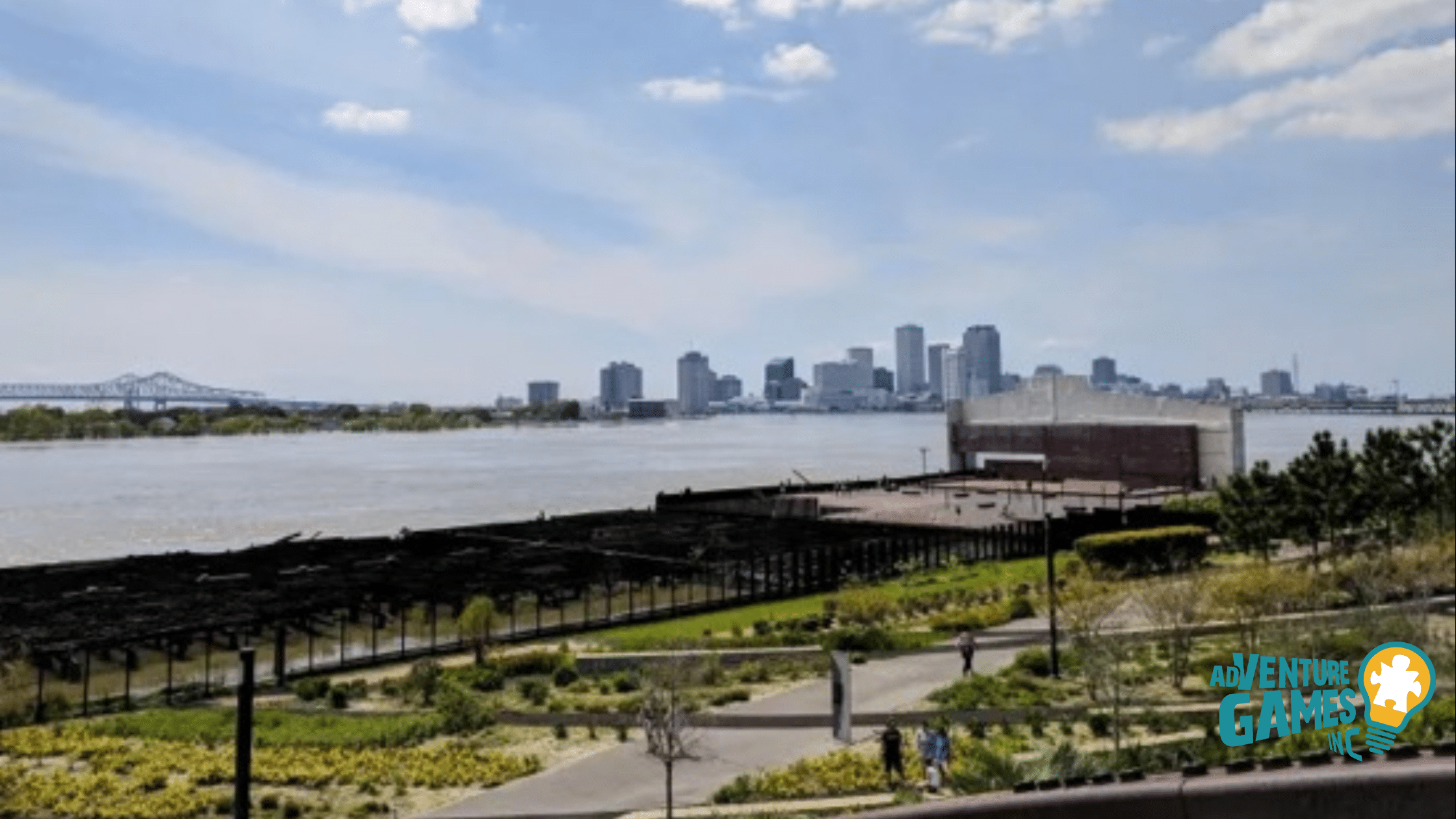 Crescent Park riverfront gardens facing the New Orleans skyline and Mississippi River, a scenic promenade for group activities and photo ops.