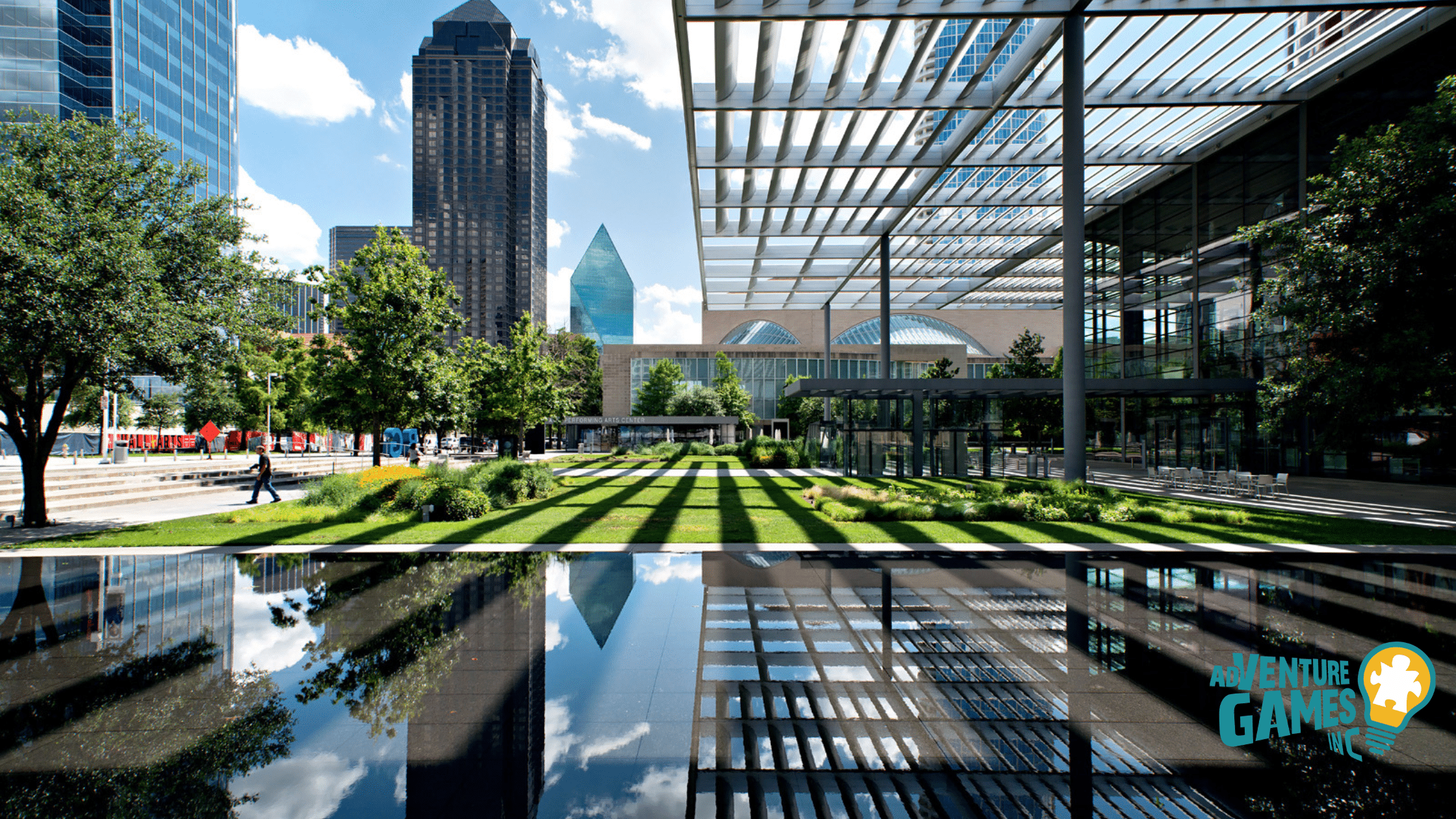 Pergola shaded lawn and reflecting pool in the Dallas Arts District with downtown towers, a scenic spot for outdoor team building events.
