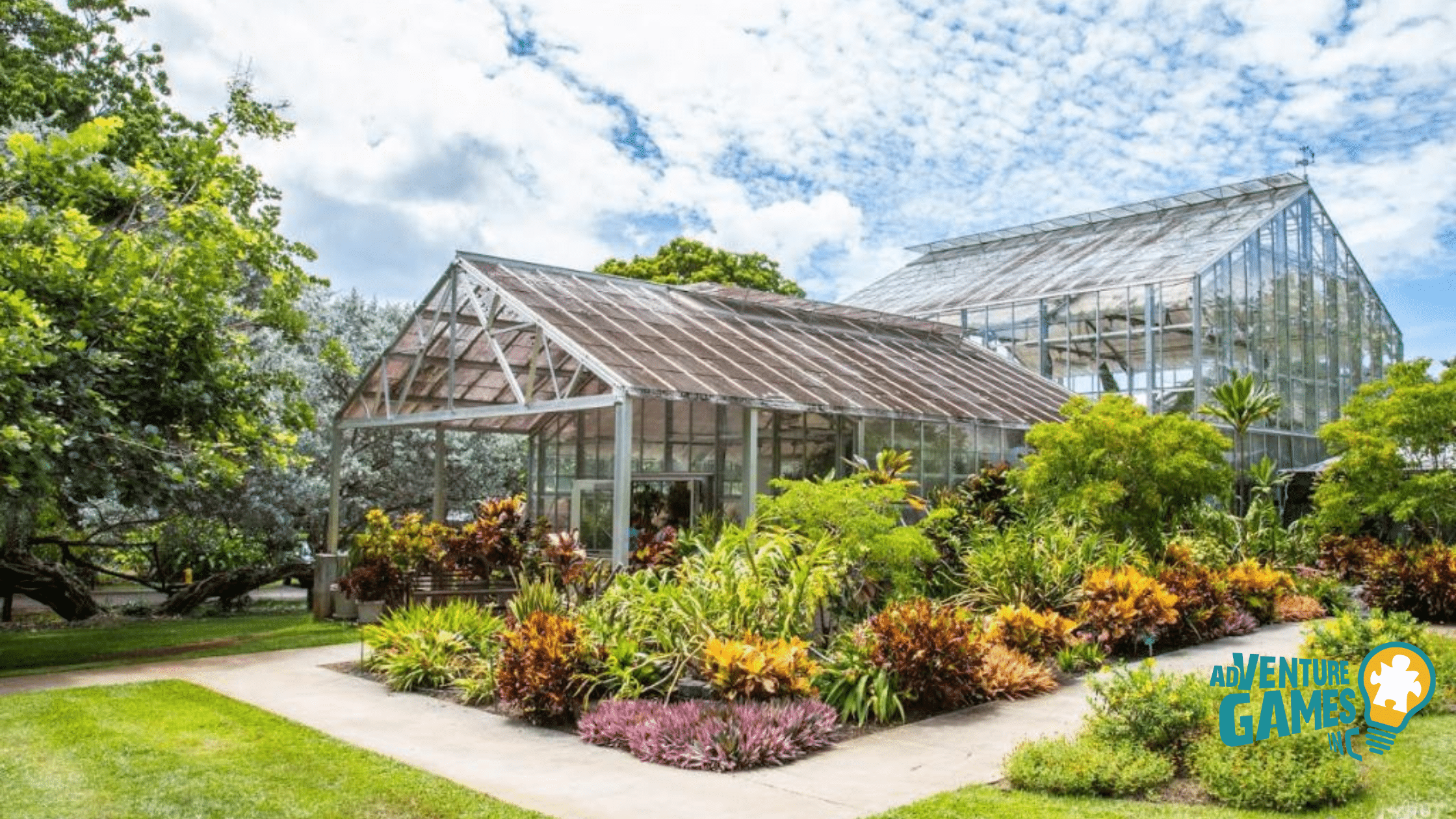 Foster Botanical Garden in Honolulu, Hawaii featuring lush tropical plants, colorful flowers, and historic greenhouse structures – Adventure Games Inc team building location in Hawaii.