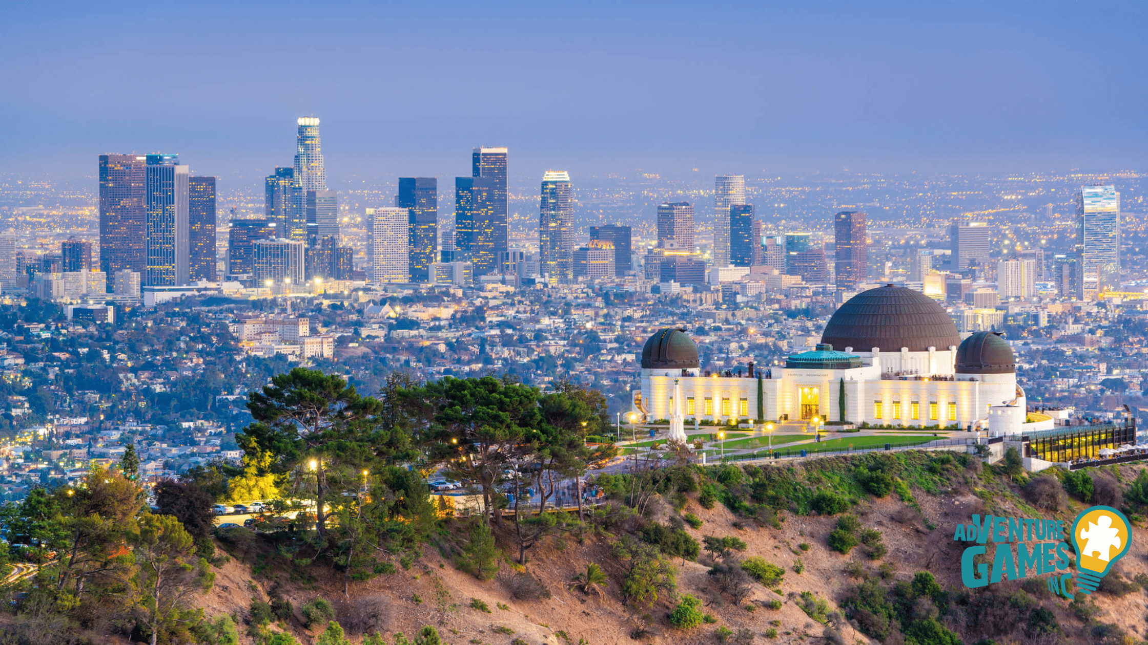 Griffith Observatory overlooking the Los Angeles skyline at sunset with glowing city lights – Adventure Games Inc premier team building backdrop.