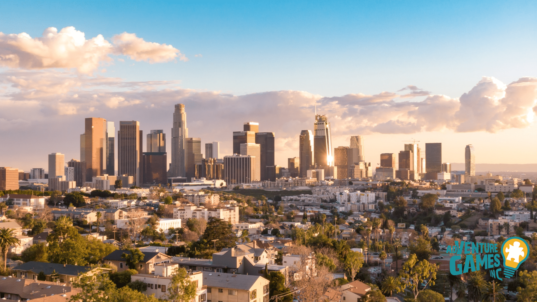 Downtown Los Angeles skyline at golden hour with tall skyscrapers and surrounding neighborhoods – Adventure Games Inc team building in Los Angeles.