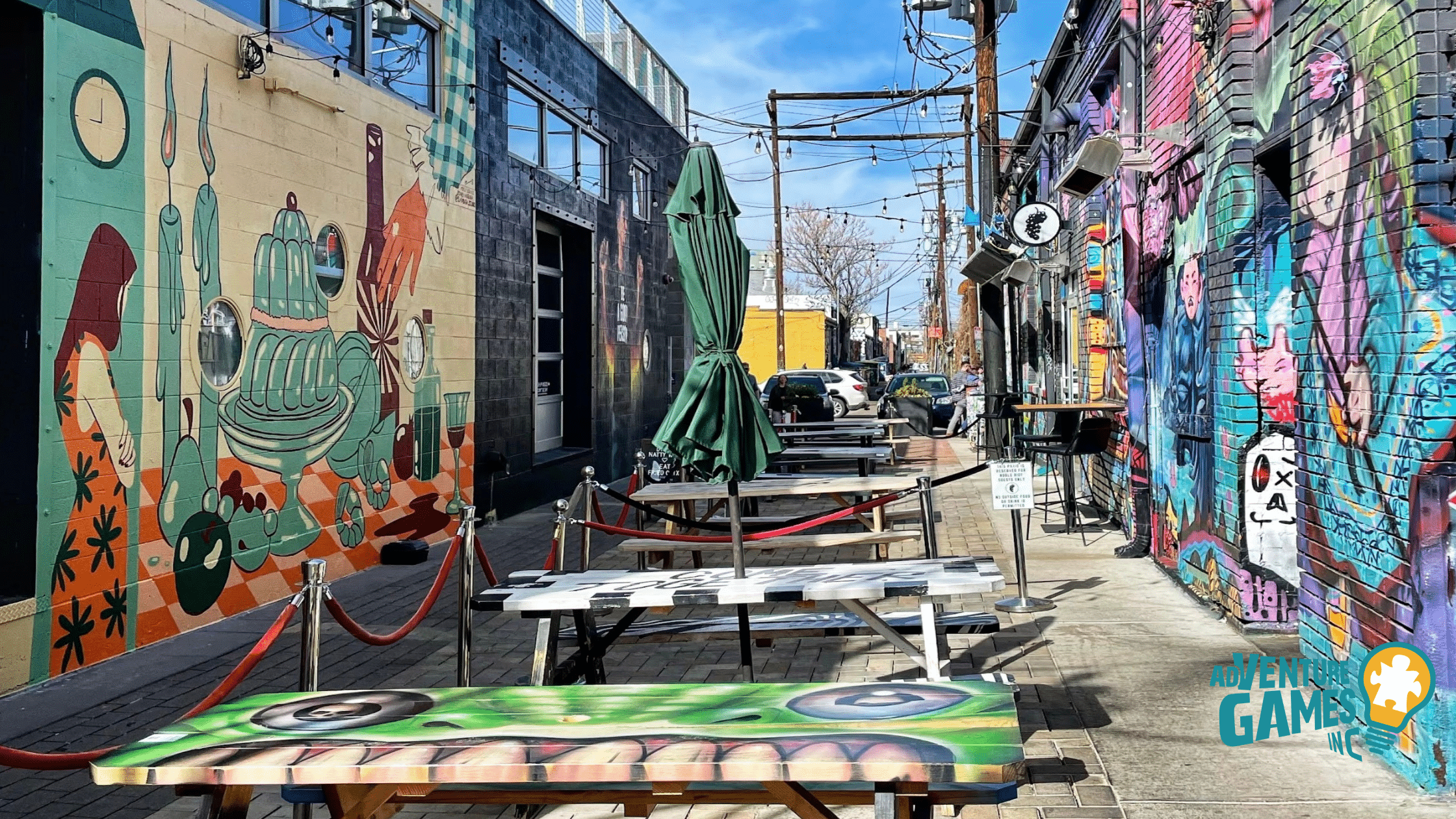 Best Team Building Denver CO by Adventure Games Inc in the RiNo Art District, colorful mural alley with tables for creative group challenges