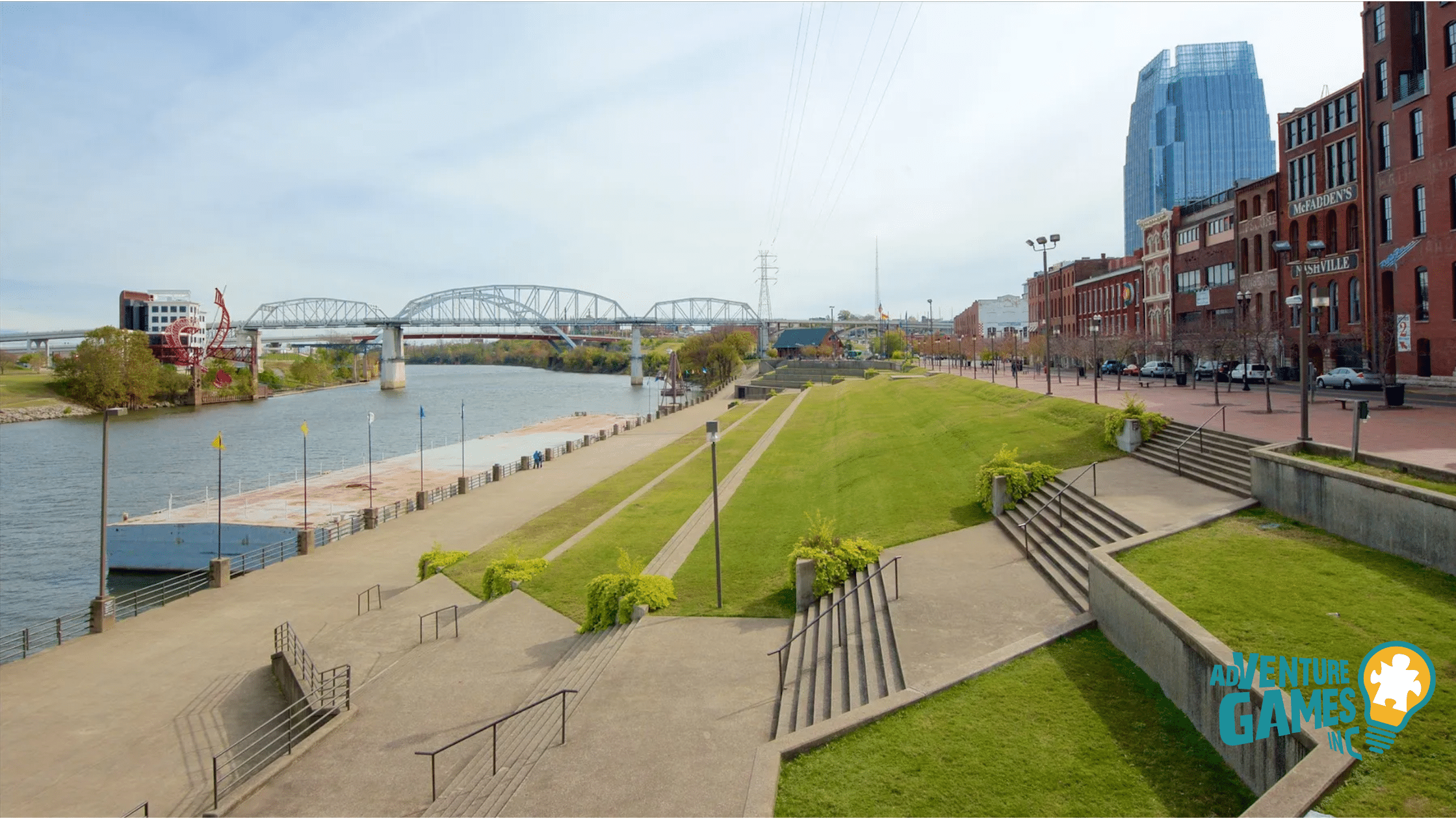 Tiered green at Riverfront Park along the Cumberland River with bridges and historic downtown buildings.