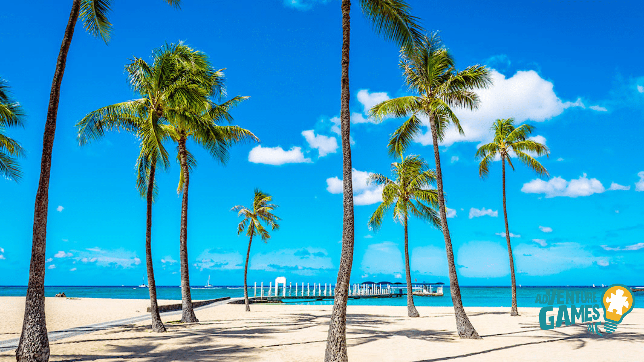 Palm trees on Waikīkī Beach Walk and Fort DeRussy Beach Park in Honolulu, Hawaii with white sand and blue ocean – Adventure Games Inc team building in Hawaii.