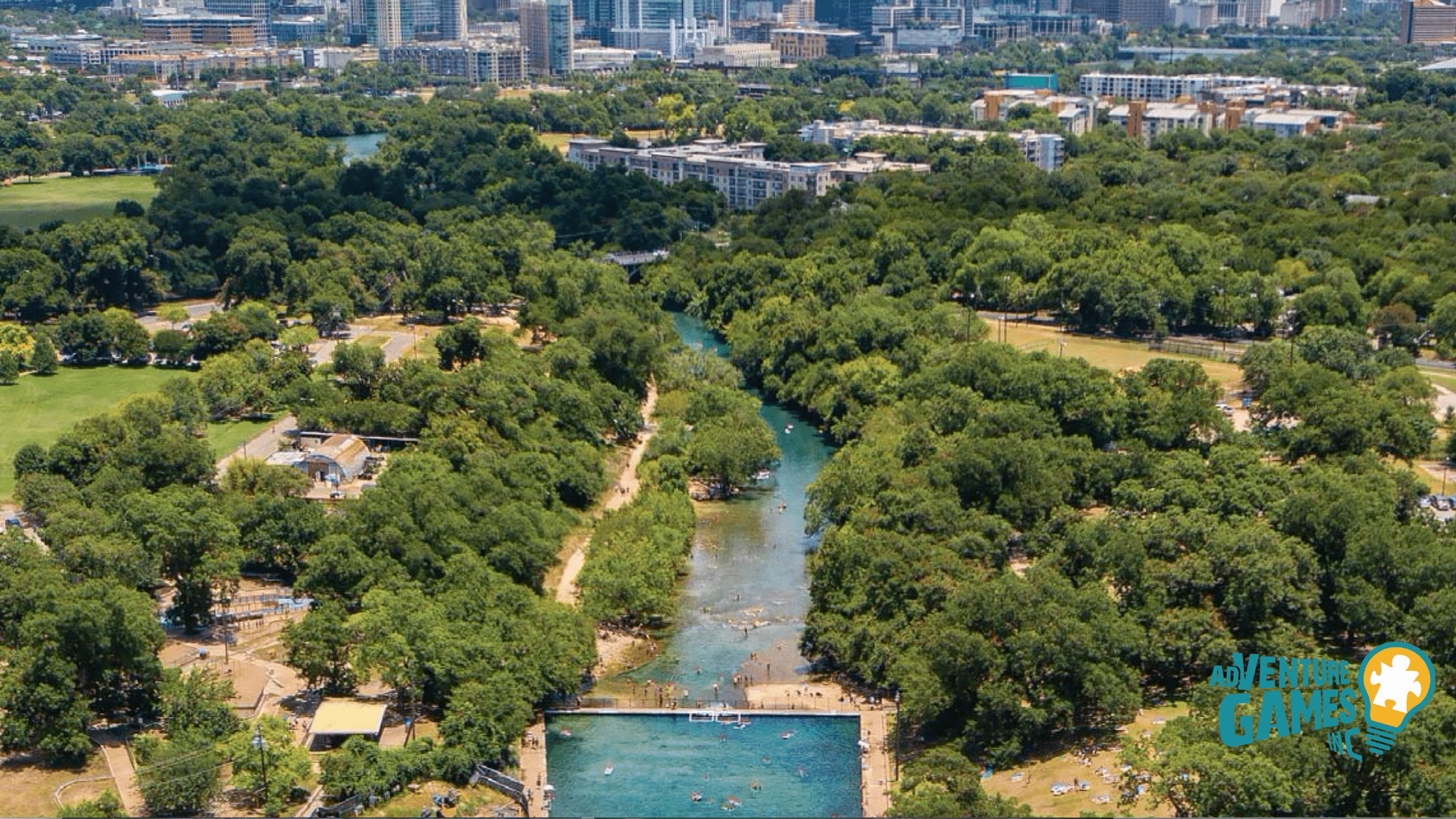 Zilker Metropolitan Park and Barton Springs aerial view with downtown in the distance, best outdoor team building venue in Austin TX