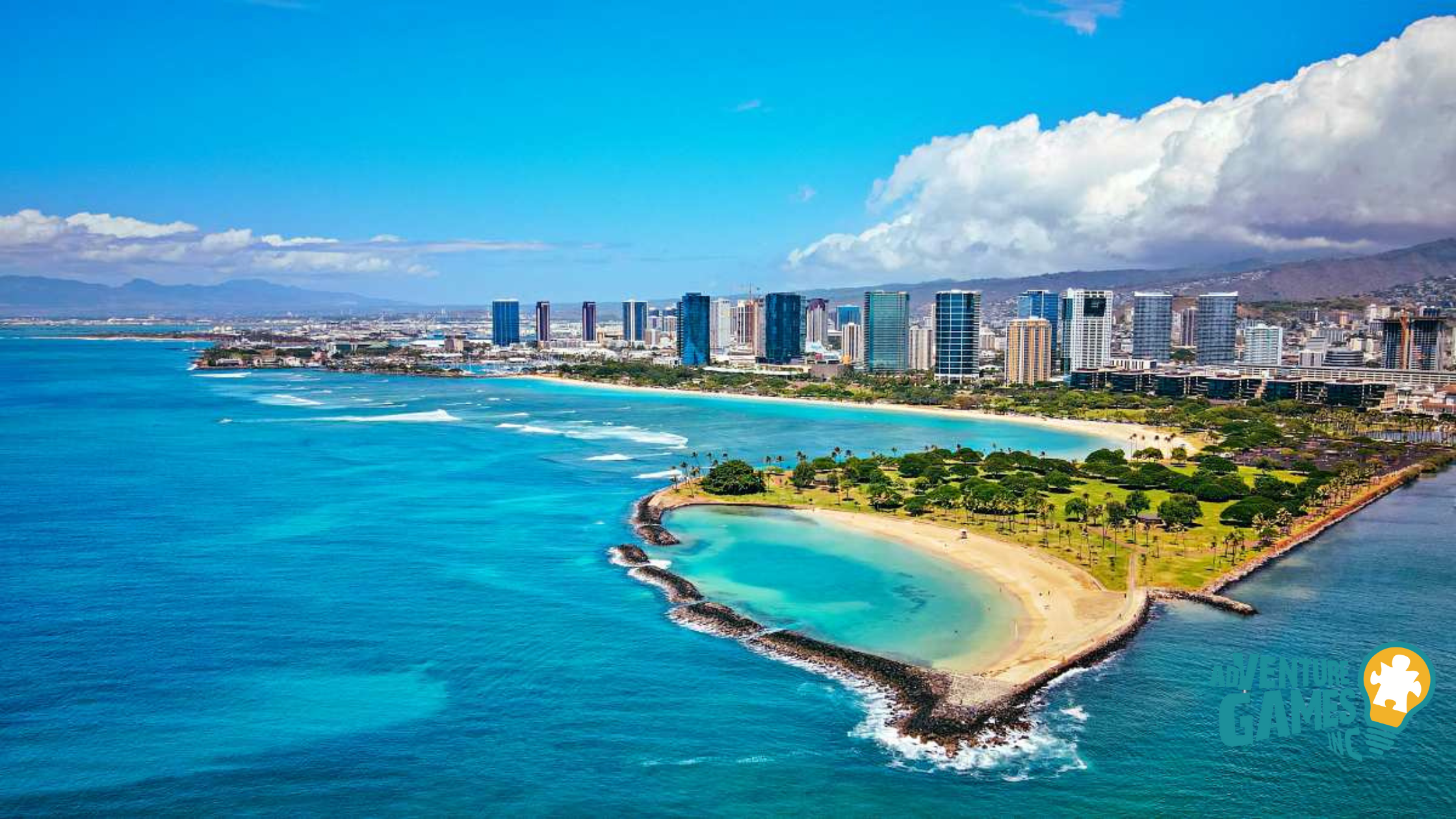 Ala Moana Beach Park in Honolulu, Hawaii with turquoise waters, sandy shoreline, and the city skyline in the background – Adventure Games Inc best team building in Hawaii.