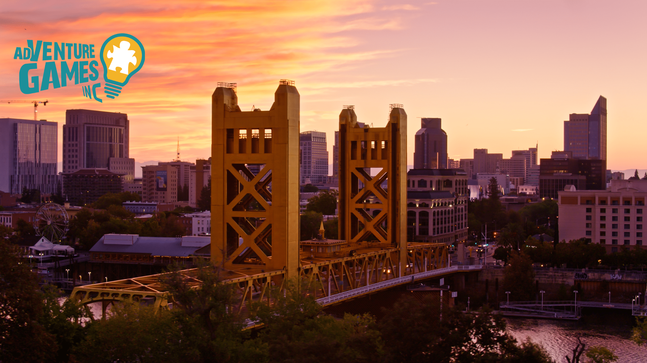 Tower Bridge glowing at sunset over the Sacramento River, viewed from a hill.